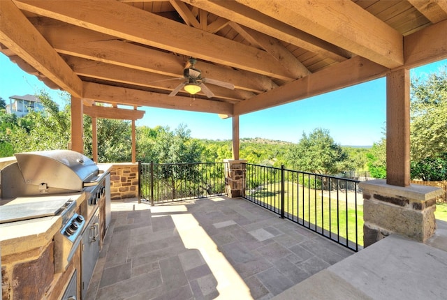 view of patio / terrace with an outdoor kitchen, ceiling fan, and grilling area