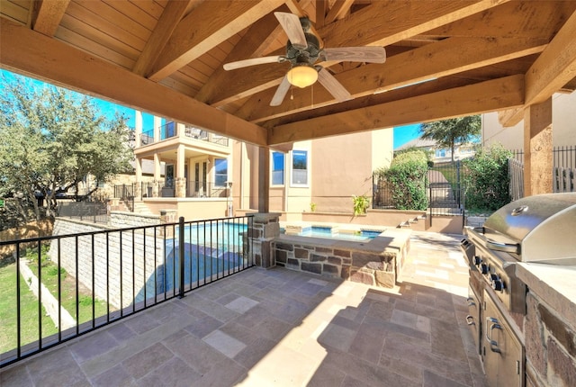 view of patio / terrace with a pool with hot tub, grilling area, ceiling fan, and exterior kitchen