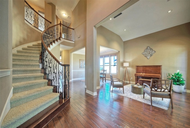 entrance foyer featuring dark hardwood / wood-style flooring and high vaulted ceiling