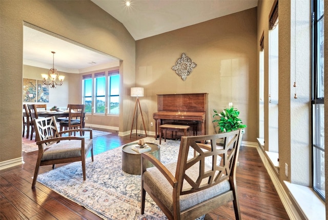 living area featuring crown molding, dark hardwood / wood-style flooring, a chandelier, and vaulted ceiling