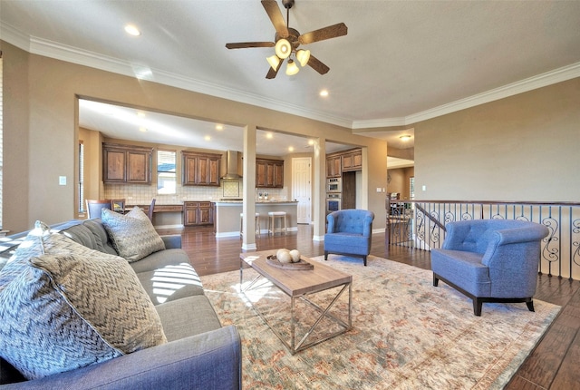 living room with ceiling fan, dark wood-type flooring, and ornamental molding