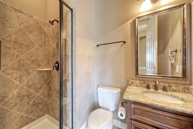 bathroom featuring vanity, toilet, and a shower with door