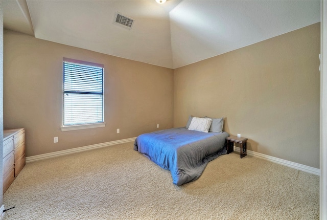 bedroom with carpet floors and vaulted ceiling