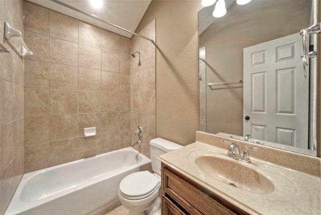 full bathroom with vanity, toilet, tiled shower / bath, and vaulted ceiling