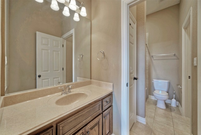 bathroom with tile patterned floors, vanity, and toilet