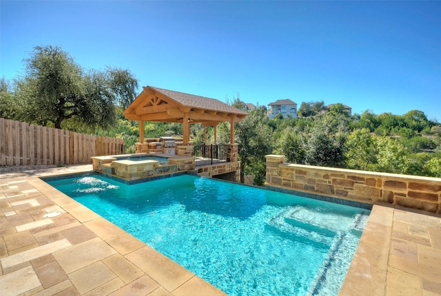 view of swimming pool featuring an in ground hot tub, a gazebo, a patio, and pool water feature