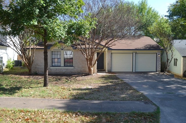 view of front of home with cooling unit and a garage