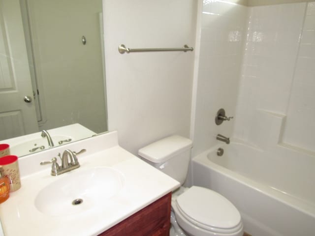 full bathroom with toilet, vanity, and tub / shower combination