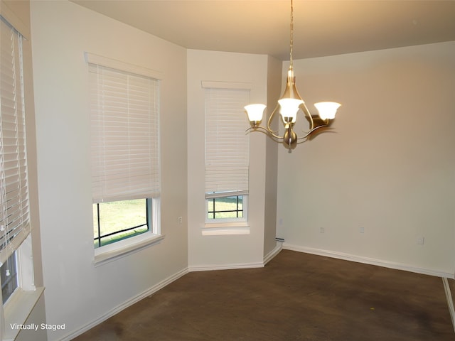 unfurnished room featuring an inviting chandelier