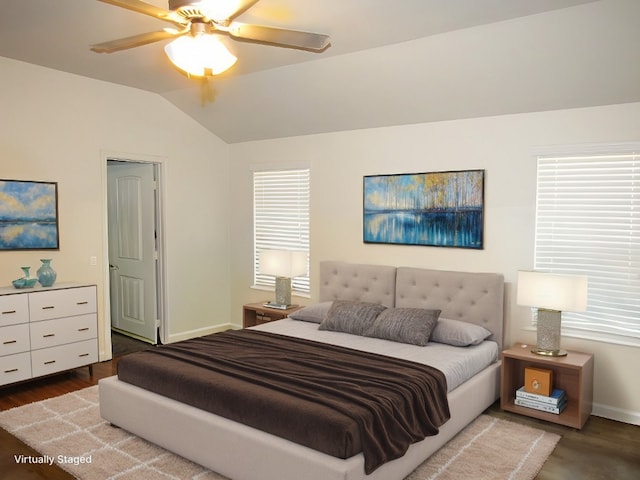 bedroom featuring ceiling fan, lofted ceiling, dark wood-type flooring, and multiple windows