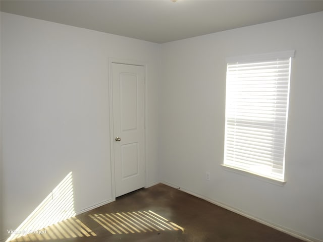 carpeted empty room featuring plenty of natural light