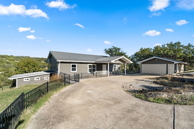 21200 Bertram Ln, Spicewood, TX 78669 - ranch-style house with an outdoor structure, concrete driveway, a garage, and metal roof