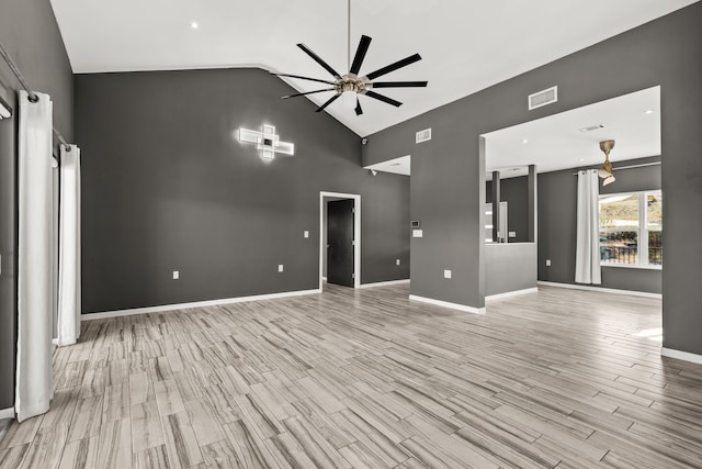 unfurnished living room with ceiling fan, light hardwood / wood-style floors, and vaulted ceiling