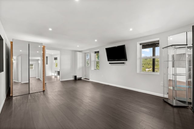 unfurnished living room with dark hardwood / wood-style flooring