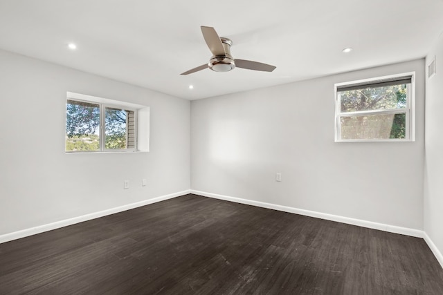 spare room featuring dark hardwood / wood-style floors and ceiling fan