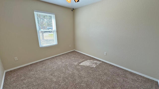 spare room featuring carpet flooring and ceiling fan