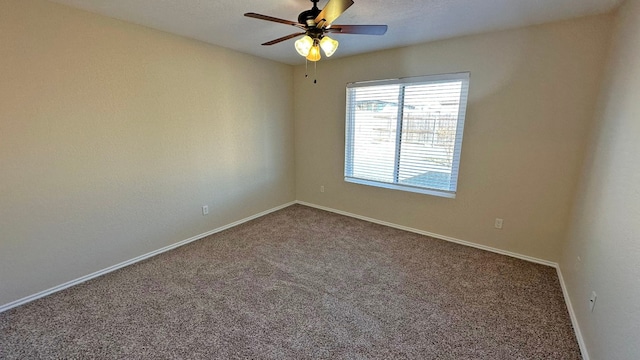 carpeted empty room featuring ceiling fan