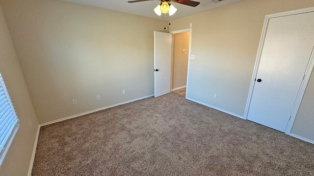 unfurnished bedroom featuring ceiling fan and carpet