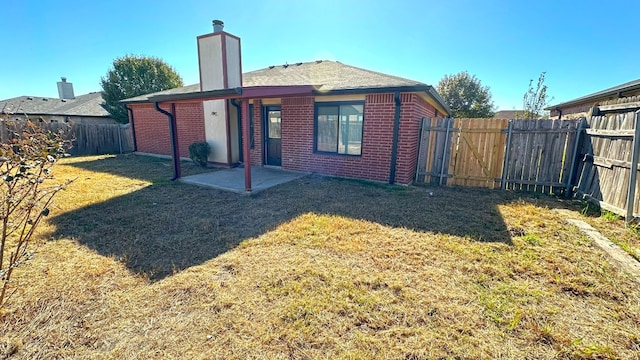 back of property featuring a lawn