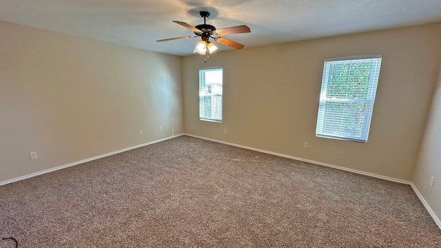 carpeted spare room with ceiling fan