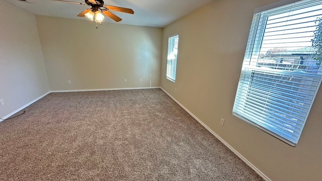 spare room featuring ceiling fan and carpet floors