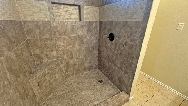 bathroom featuring tile patterned floors and a tile shower