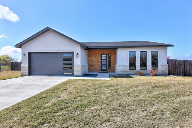 view of front of home with a front lawn and a garage