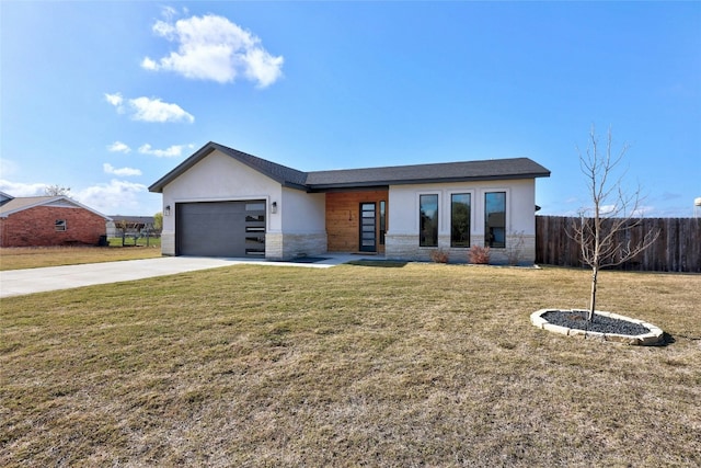 view of front of property featuring a garage and a front lawn