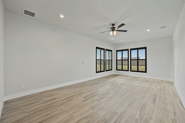 spare room featuring ceiling fan and light hardwood / wood-style flooring