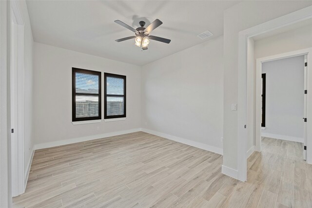 empty room featuring ceiling fan and light hardwood / wood-style floors