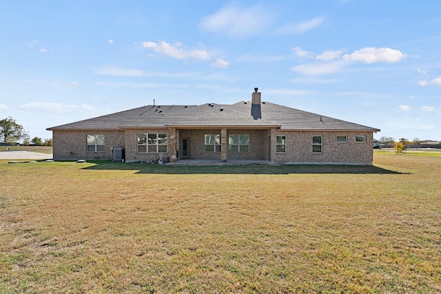 rear view of house featuring central AC, a patio area, and a yard