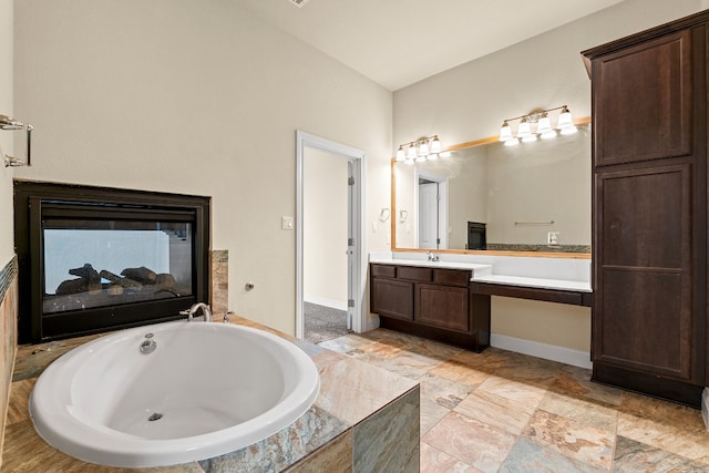 bathroom featuring vanity and a relaxing tiled tub