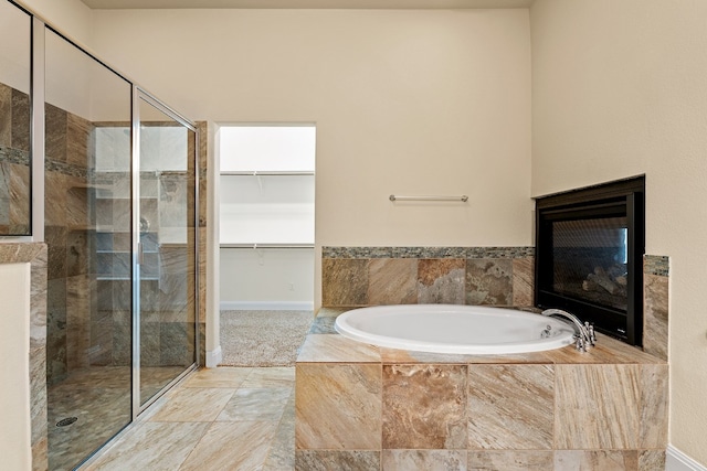 bathroom featuring separate shower and tub