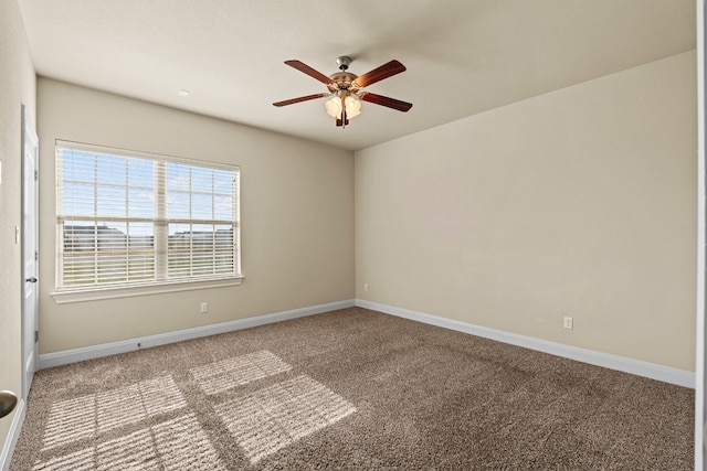 spare room featuring ceiling fan and carpet