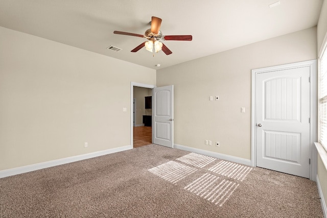 unfurnished bedroom featuring ceiling fan and carpet floors