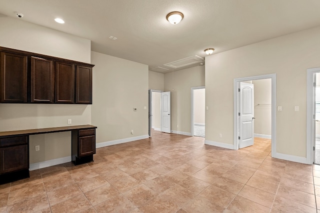 kitchen with dark brown cabinets and built in desk