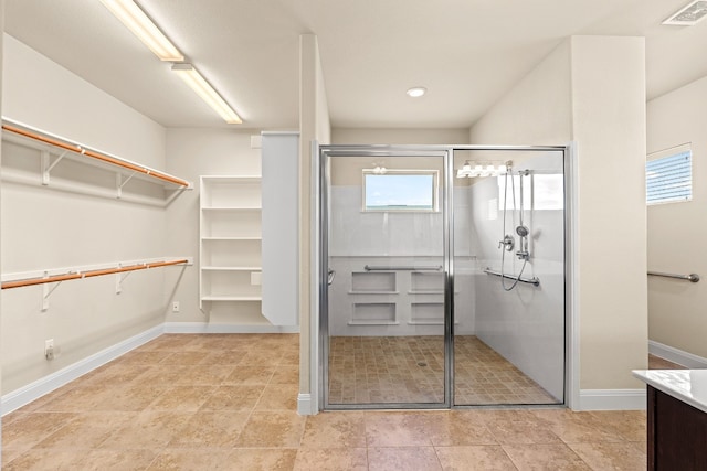 interior space featuring vanity and walk in shower