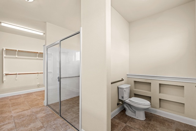 bathroom with an enclosed shower and toilet