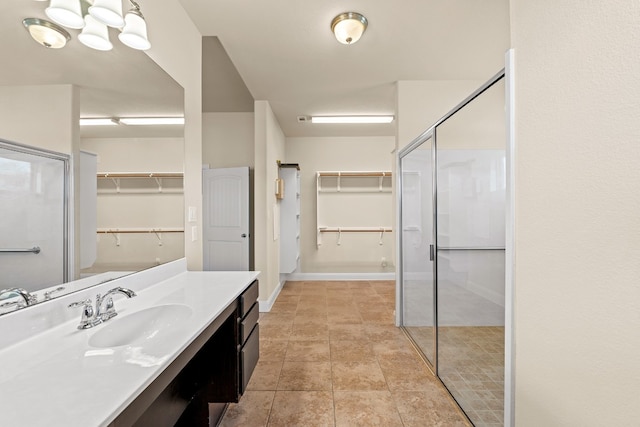 bathroom featuring vanity and a shower with shower door