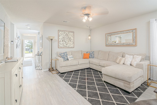 living room featuring dark hardwood / wood-style floors and ceiling fan