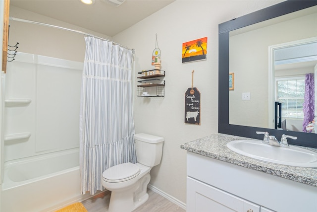 full bathroom with hardwood / wood-style flooring, vanity, toilet, and shower / bath combo with shower curtain