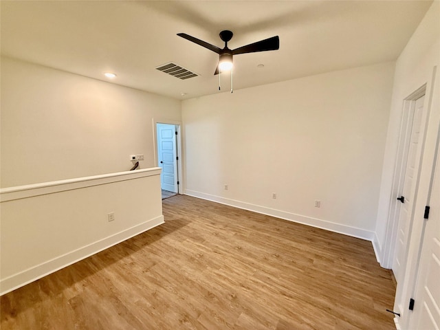 spare room featuring ceiling fan and hardwood / wood-style floors