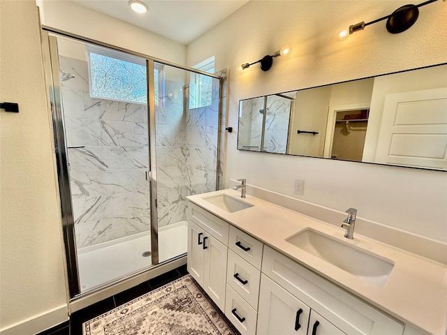 bathroom featuring vanity, an enclosed shower, and tile patterned flooring