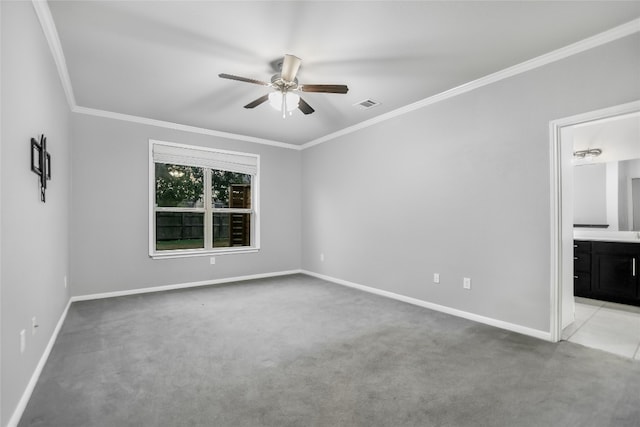 carpeted spare room featuring ceiling fan and ornamental molding