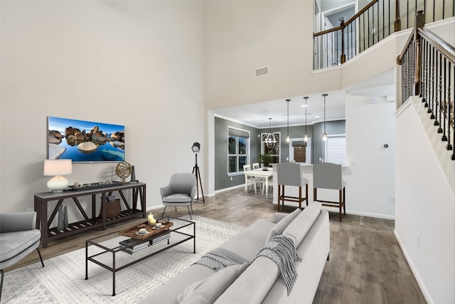 living room with hardwood / wood-style flooring and a high ceiling