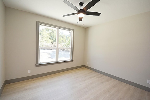 empty room with ceiling fan and light hardwood / wood-style flooring