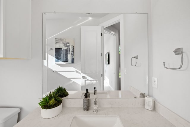 bathroom with vanity and toilet