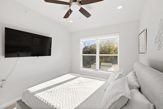 carpeted bedroom with ceiling fan and lofted ceiling