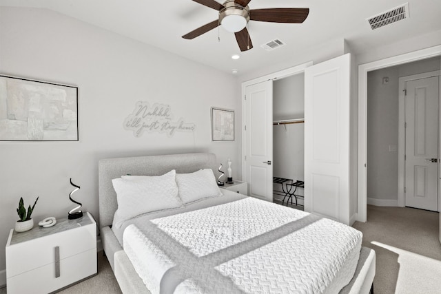 carpeted bedroom with ceiling fan and a closet