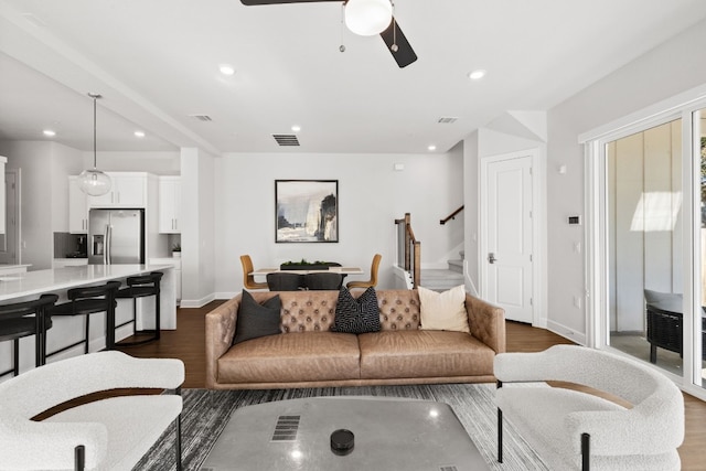 living room with dark hardwood / wood-style floors and ceiling fan